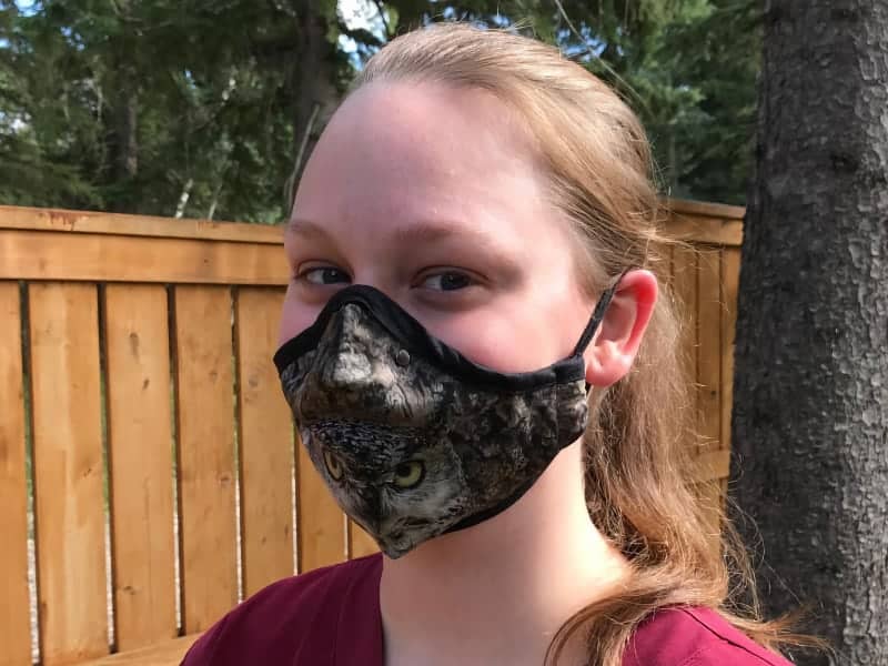 Woman wearing face mask with wildlife pattern