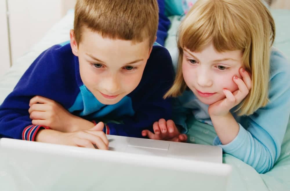 Kids reading computer screen