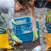 Kids clearing bottles from beach