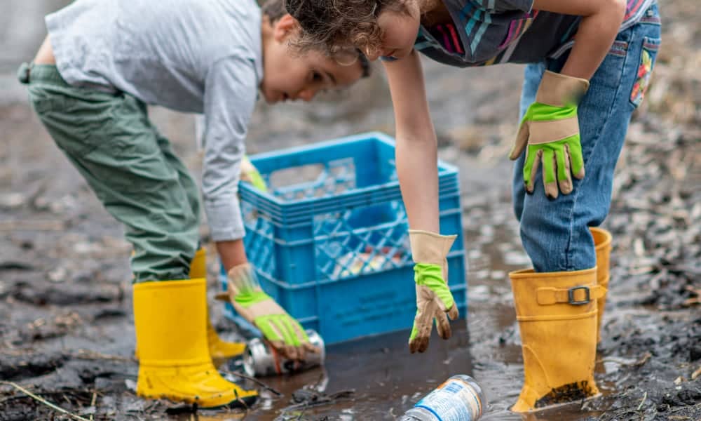 Kids clearing bottles from beach