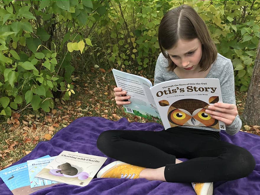 Child reading book about owls
